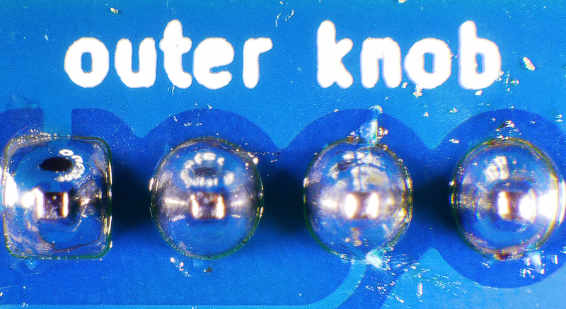 Photo of a board with four good quality solder connections.